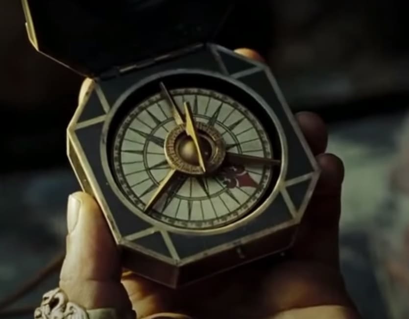 A person holding a compass in a hand.