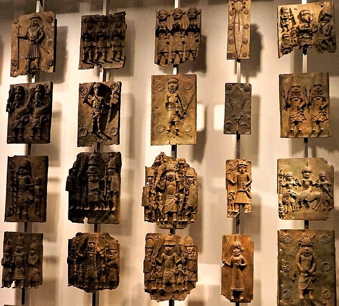 A display of wooden carvings on a wall.