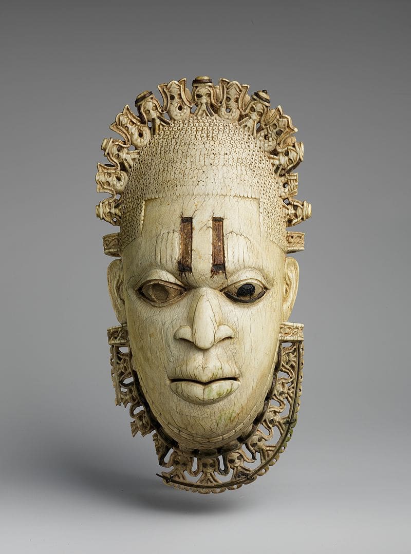 A wooden mask with a carved face.