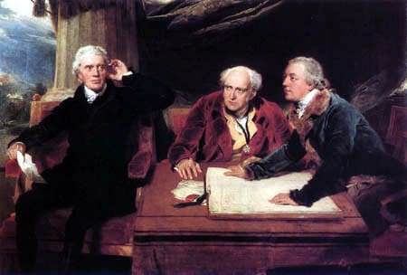 Three men sitting at a table with papers.