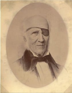 An old photograph of a man with a bow tie.