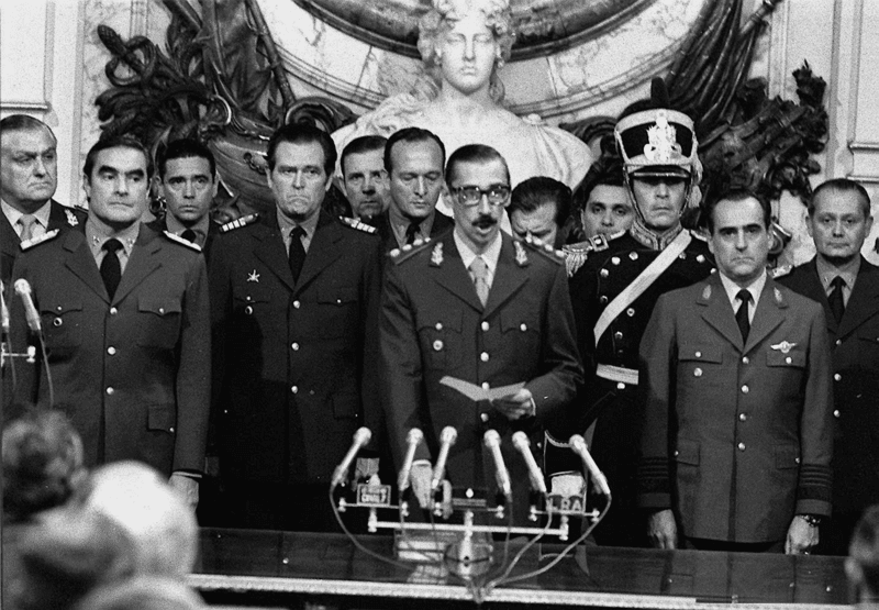 A group of men standing in front of microphones.