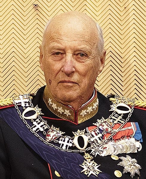 A man in a military uniform wearing a sash.