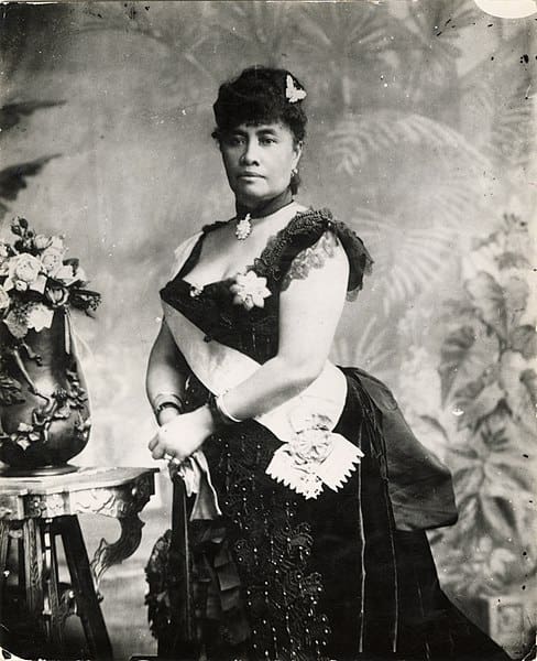 An old photo of a woman in a dress.